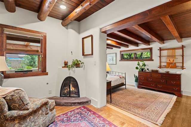 sitting room with beam ceiling, light hardwood / wood-style flooring, and wooden ceiling