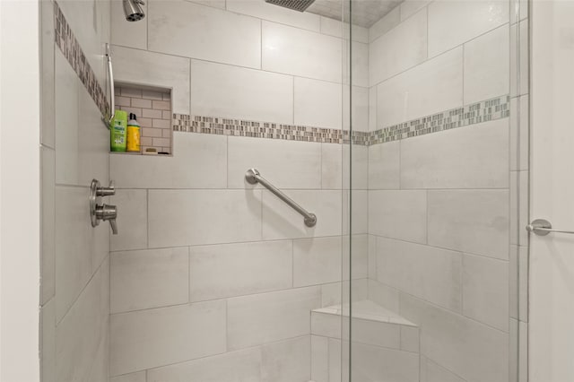 bathroom with a tile shower