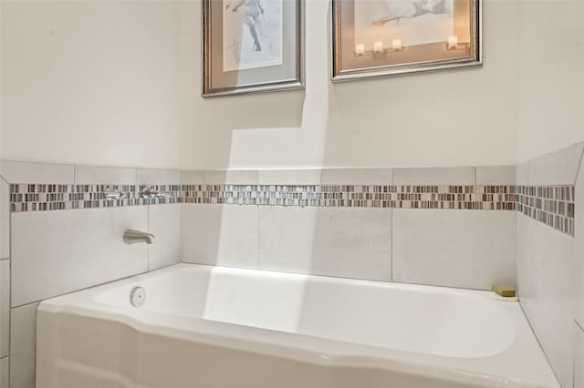 bathroom with a tub to relax in