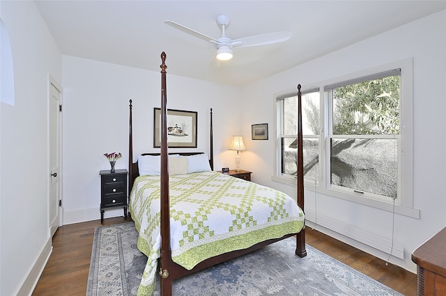 bedroom with dark hardwood / wood-style floors and ceiling fan