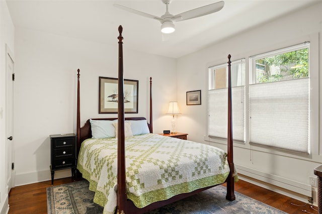 bedroom with dark hardwood / wood-style floors and ceiling fan