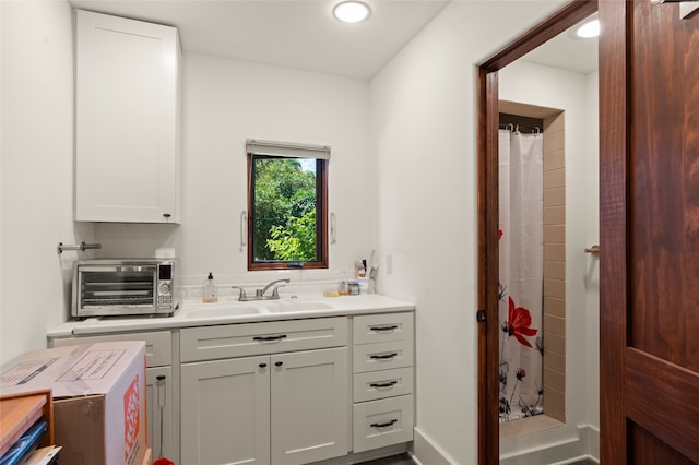 bathroom featuring vanity and curtained shower