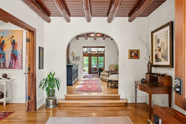 entryway featuring wood-type flooring, beam ceiling, and wooden ceiling