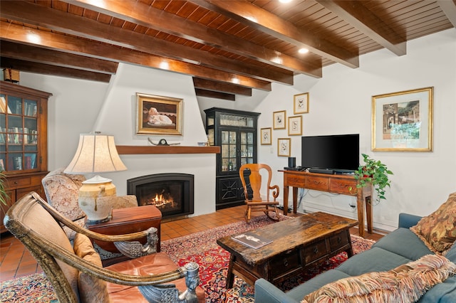 tiled living room with beam ceiling, wood ceiling, and a large fireplace