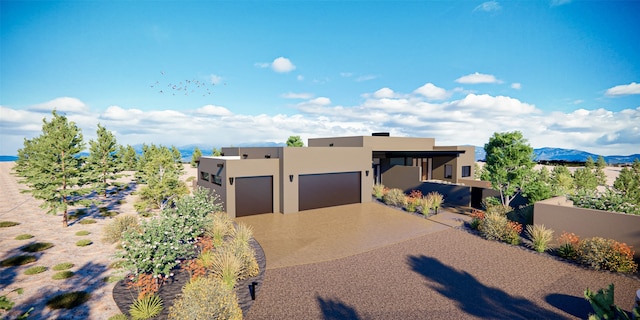 pueblo-style house featuring a garage and a mountain view