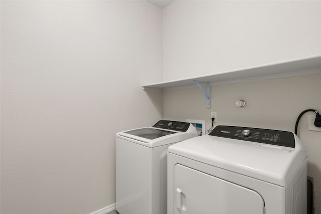 clothes washing area with washing machine and clothes dryer