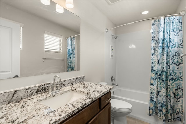 full bathroom featuring tile patterned flooring, shower / bath combo, vanity, and toilet