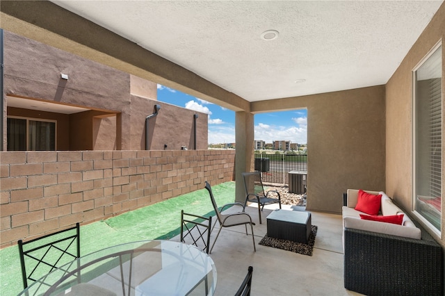 view of patio / terrace featuring an outdoor living space and central air condition unit