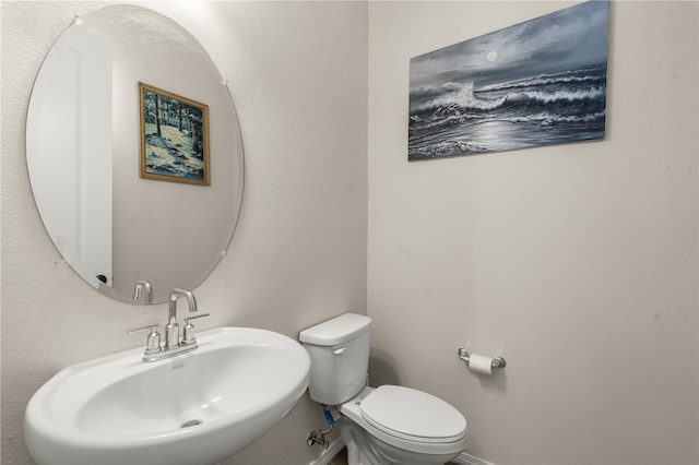 bathroom featuring toilet and sink