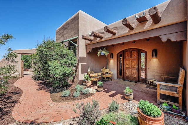 doorway to property with a patio