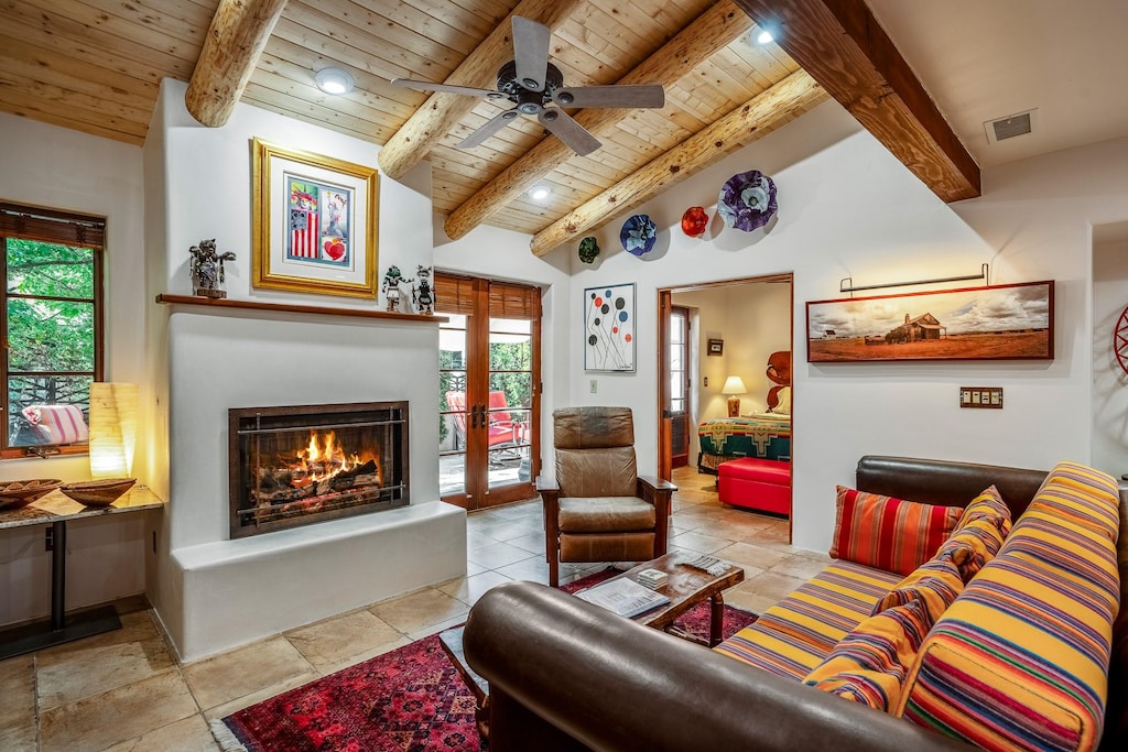 living room with french doors, wooden ceiling, vaulted ceiling with beams, and ceiling fan