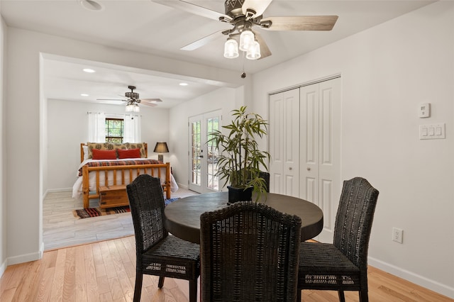 dining area with ceiling fan and light hardwood / wood-style floors