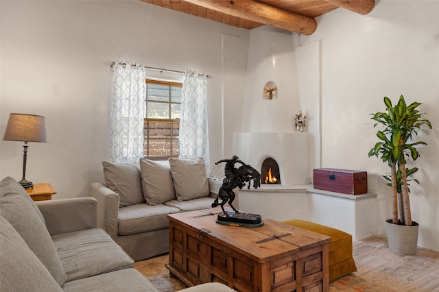 living room with wooden ceiling, light wood-type flooring, beamed ceiling, and a fireplace