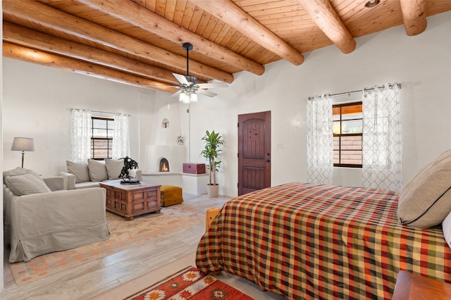 bedroom featuring wooden ceiling, multiple windows, beam ceiling, and ceiling fan