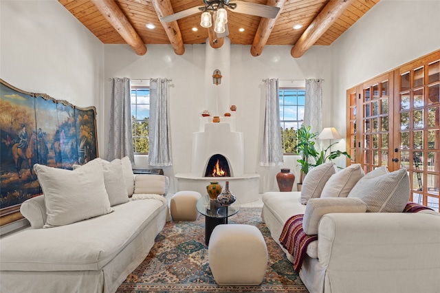 living room with beam ceiling, wood ceiling, and a healthy amount of sunlight