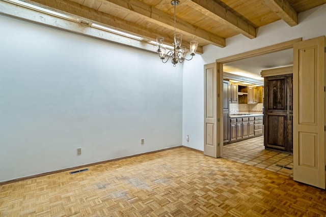 empty room featuring a chandelier, wooden ceiling, visible vents, baseboards, and beam ceiling