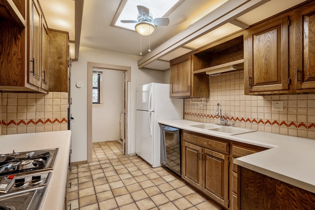 kitchen with a sink, stainless steel gas cooktop, decorative backsplash, and dishwasher