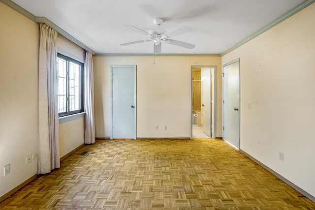 unfurnished bedroom with a ceiling fan, baseboards, crown molding, and ensuite bathroom