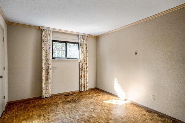 unfurnished room with baseboards and ornamental molding