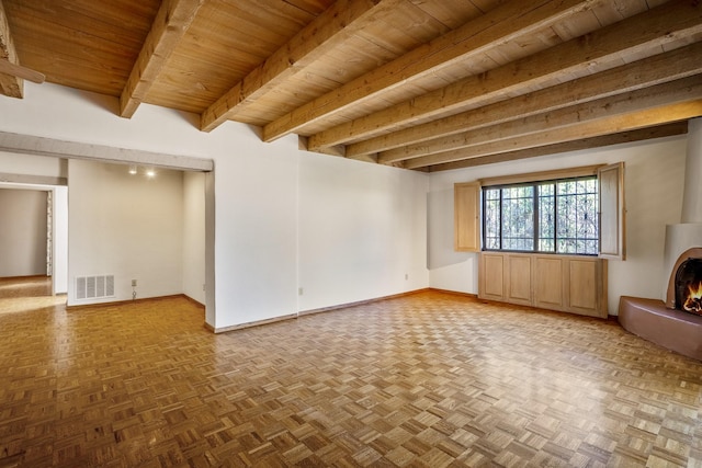 unfurnished room with wood ceiling, visible vents, baseboards, a lit fireplace, and beam ceiling