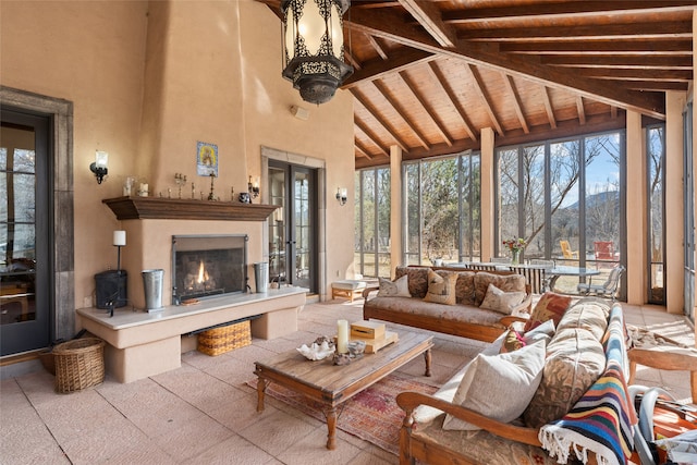 sunroom / solarium with vaulted ceiling with beams and wooden ceiling