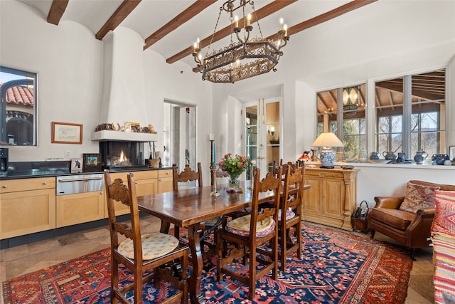 dining area featuring beamed ceiling, a high ceiling, and a notable chandelier