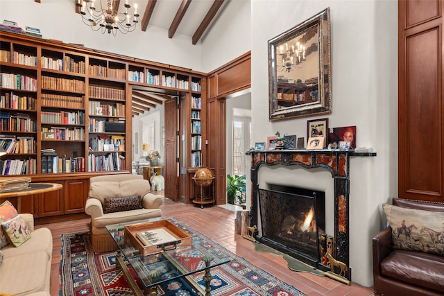 sitting room featuring lofted ceiling with beams and a notable chandelier