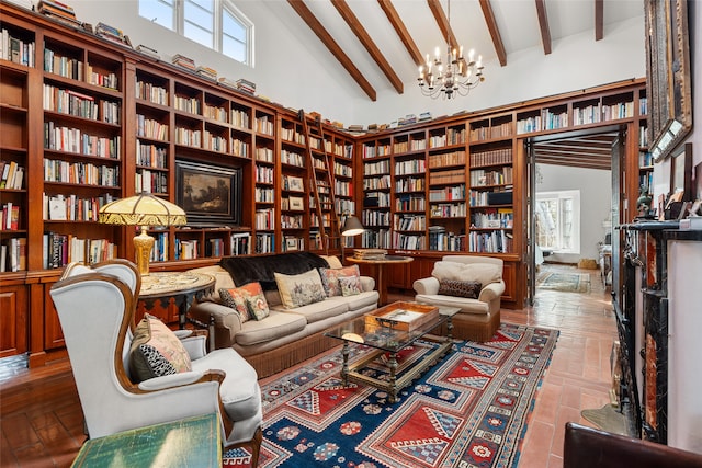 living area featuring beamed ceiling, plenty of natural light, high vaulted ceiling, and an inviting chandelier