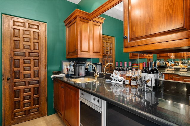 kitchen featuring dark stone countertops and sink