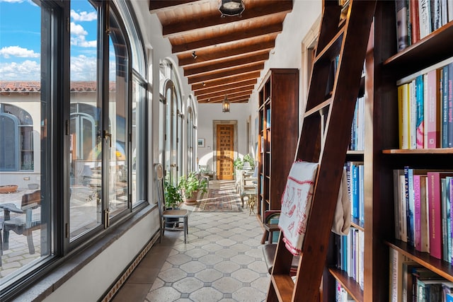 corridor with vaulted ceiling with beams and wood ceiling