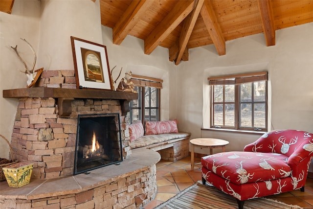 tiled living room with a stone fireplace, a wealth of natural light, wood ceiling, and lofted ceiling with beams