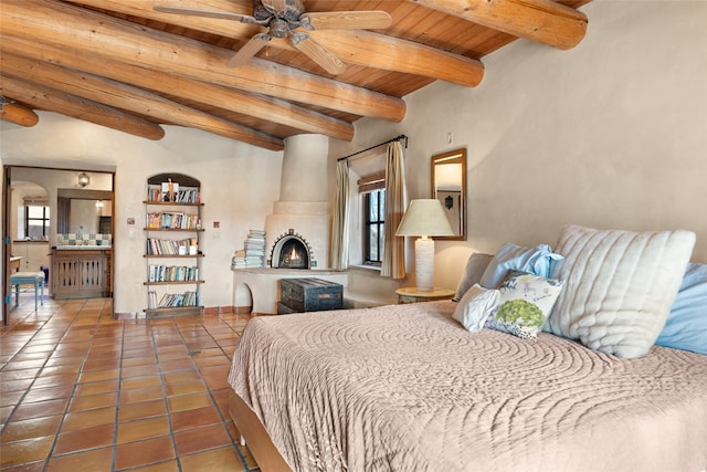 tiled bedroom featuring beam ceiling, multiple windows, connected bathroom, and wood ceiling