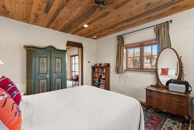 bedroom with wood ceiling and multiple windows