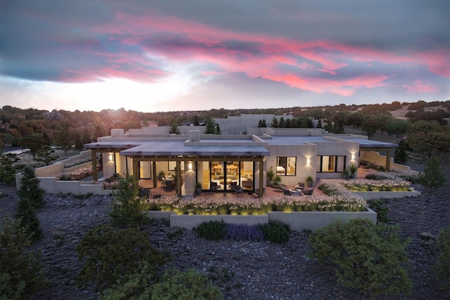 view of back house at dusk