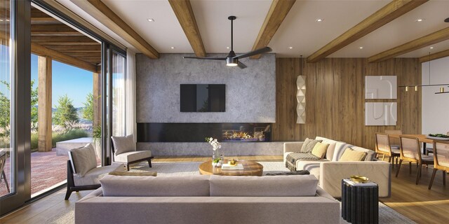 living room with beamed ceiling, wood-type flooring, and a healthy amount of sunlight