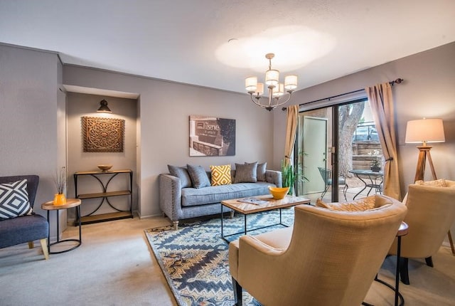 carpeted living room featuring a notable chandelier