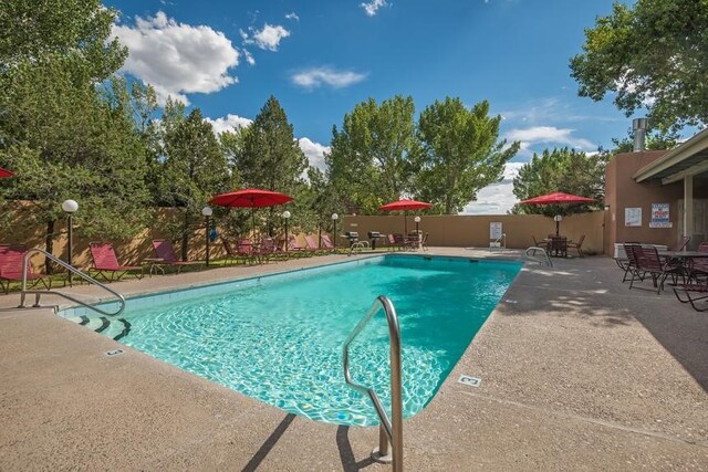 view of swimming pool with a patio