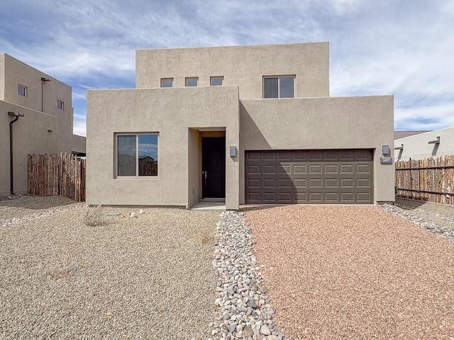 3497 Aster Ln, Santa Fe, NM 87507 - view of front of property with fence, driveway, stucco siding, and a garage