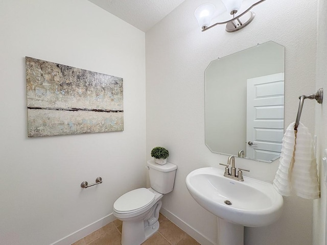 3497 Aster Ln, Santa Fe, NM 87507 - bathroom featuring baseboards, a sink, toilet, and tile patterned flooring