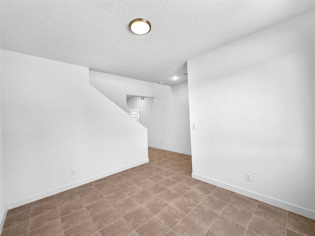 basement featuring a textured ceiling