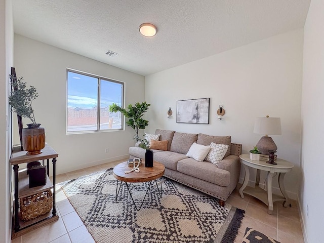 3497 Aster Ln, Santa Fe, NM 87507 - living room with light tile patterned flooring, a textured ceiling, baseboards, and visible vents