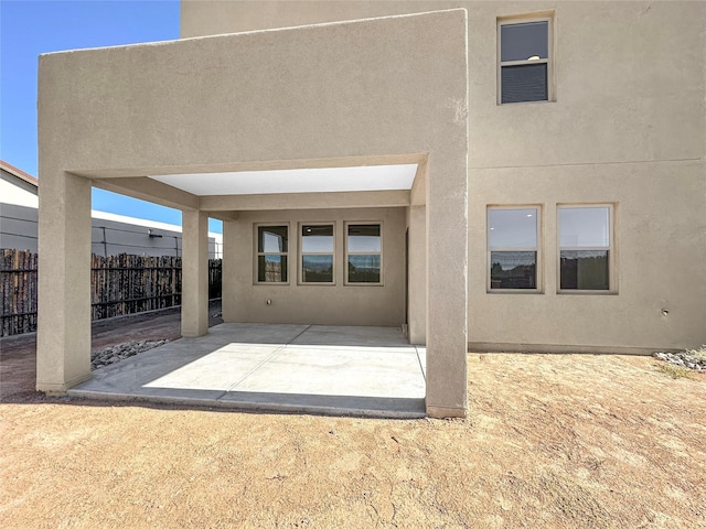 3497 Aster Ln, Santa Fe, NM 87507 - rear view of property with stucco siding, fence, and a patio area