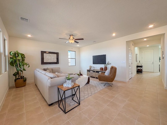 3497 Aster Ln, Santa Fe, NM 87507 - living room with a textured ceiling, ceiling fan, visible vents, and light tile patterned floors
