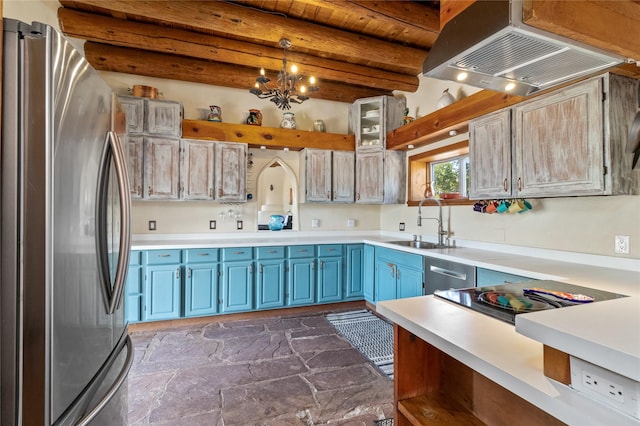 kitchen with light countertops, stainless steel appliances, blue cabinetry, a sink, and exhaust hood