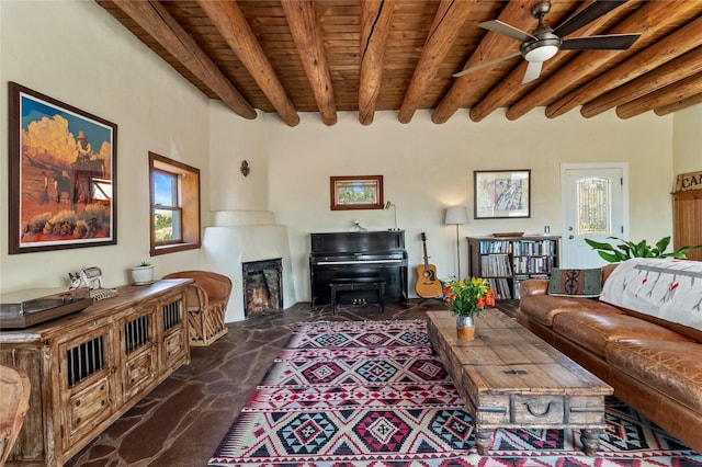 living area with a warm lit fireplace, wood ceiling, ceiling fan, and beamed ceiling