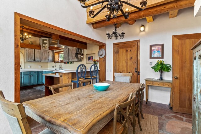 dining space with a notable chandelier, a wood stove, and a high ceiling