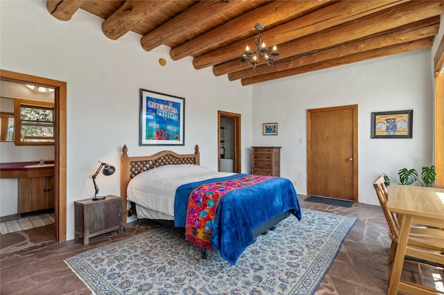 bedroom featuring stone tile floors, connected bathroom, wooden ceiling, beamed ceiling, and an inviting chandelier