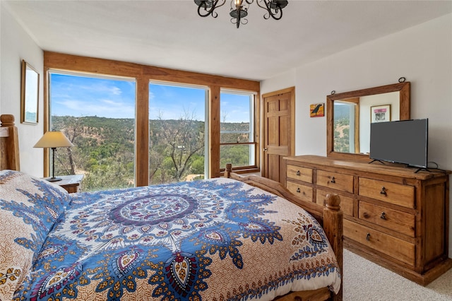 bedroom featuring carpet floors and a notable chandelier