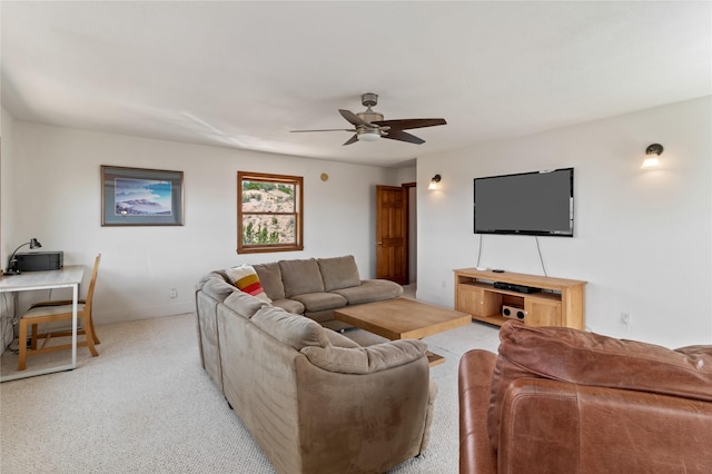 living area with a ceiling fan and light carpet