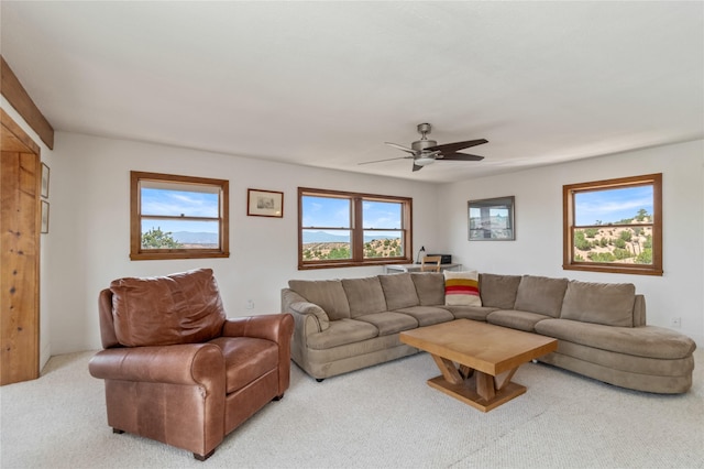 carpeted living room with a ceiling fan